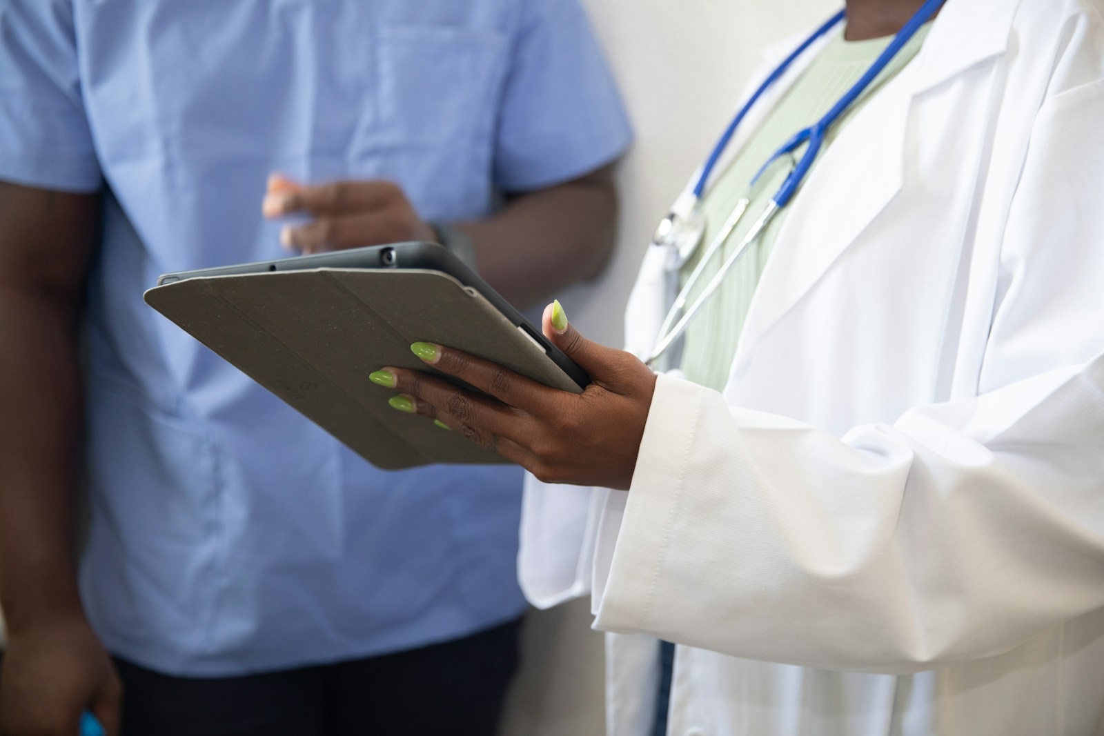 Clinician and colleague reviewing biomarker data on a tablet